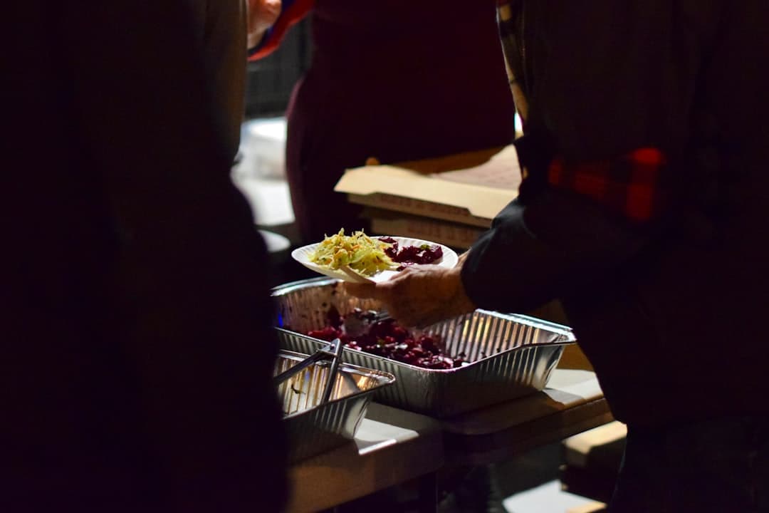 Volunteers serving a hot, freshly prepared meal