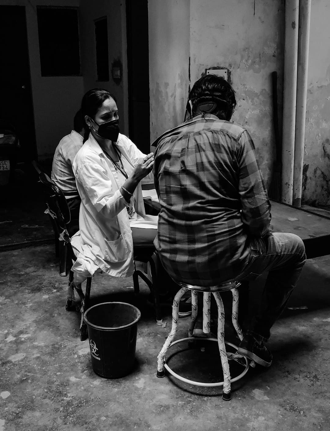 A health worker examining a patient during a checkup